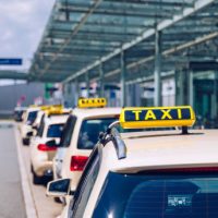 Taxi sign on the roof of a vehicle. Taxi cars on the street waiting for passengers. Selective focused image. Waiting taxi cars in the city.