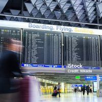 Frankfurt am Main, Germany - March 06, 2014: Businessman and other people in motion blur walking through the Departure Hall of Frankfurt Airport Terminal 1, largest Airport of Germany. Terminal 1 services over 40 Million passengers per year.